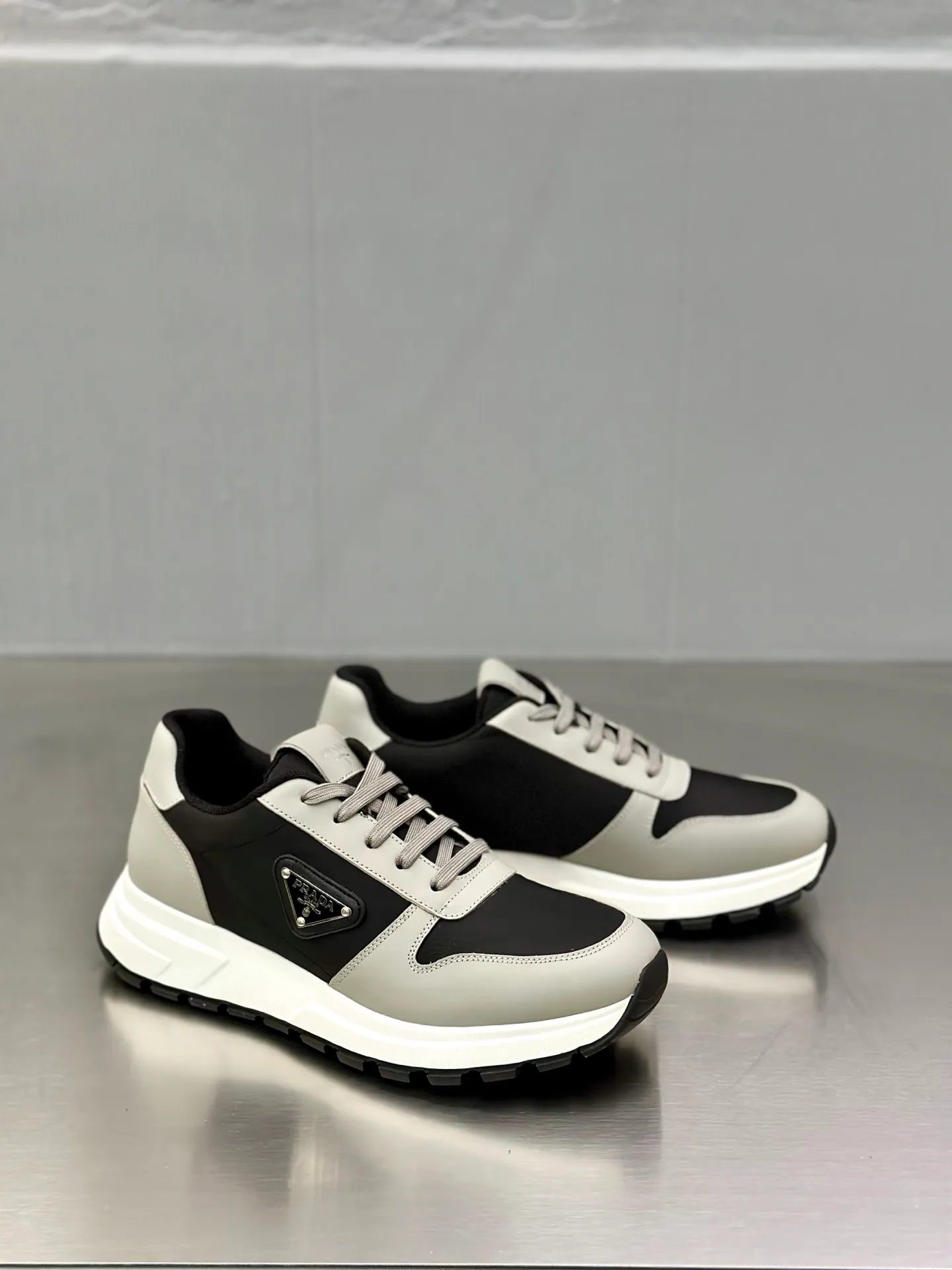 💰740 Prada/Prada men's new mesh stitching sneakers. This sneaker presents a modern version, reinterpreting the brand's archive style with clean lines and smooth details. The shoes are made of calf leather and technical fabric, with a triangular metal logo on the outside, bright TPU decoration on the heel, and a longer and padded inner heel design for a more comfortable fit. The tongue is decorated with a silk-screen logo, and is paired with a hollow rubber sole on the heel. The full cowhide lining comes standard with logo cowhide foot pads, making the upper foot taller, more comfortable, and versatile! Comes with full original packaging! Size: 39-40-41-42-43-44 standard leather shoe size (45 can be customized and does not support returns)